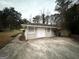 Detached garage with a large driveway and fenced backyard at 1908 Delowe Sw Pl, Atlanta, GA 30311