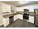 Modern kitchen featuring white cabinets and granite countertops at 1908 Delowe Sw Pl, Atlanta, GA 30311
