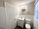Updated bathroom with white tile, vanity, and toilet at 3809 Clovis Nw Ct, Atlanta, GA 30331