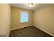 Cozy bedroom with gray carpeting and a window with blinds at 3809 Clovis Nw Ct, Atlanta, GA 30331