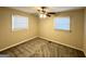 Well-lit bedroom with gray carpeting and ceiling fan at 3809 Clovis Nw Ct, Atlanta, GA 30331