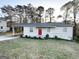 Ranch house with red door, carport, and lush green lawn at 3809 Clovis Nw Ct, Atlanta, GA 30331