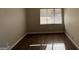 Simple bedroom with wood-look flooring and a window at 6584 Port A Prince Dr, Forest Park, GA 30297