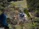 Aerial view of house near a pond and trees at 2095 Sw Flat Shoals Rd, Conyers, GA 30094