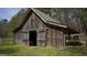 Rustic barn with double doors and fenced area at 2095 Sw Flat Shoals Rd, Conyers, GA 30094