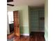 Bedroom with hardwood floors, built-in shelves, and adjacent bathroom at 2095 Sw Flat Shoals Rd, Conyers, GA 30094