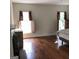 Spacious bedroom with hardwood floors, fireplace, and two windows at 2095 Sw Flat Shoals Rd, Conyers, GA 30094