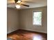 Simple bedroom with hardwood floors and ceiling fan at 2095 Sw Flat Shoals Rd, Conyers, GA 30094