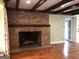 Brick fireplace with wood mantle and hardwood floors at 2095 Sw Flat Shoals Rd, Conyers, GA 30094