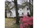 White two-story house with azaleas in front at 2095 Sw Flat Shoals Rd, Conyers, GA 30094