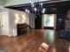 Spacious living room featuring hardwood floors, a chandelier, and built-in shelving at 2095 Sw Flat Shoals Rd, Conyers, GA 30094