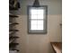 Storage room with wood shelving and single window at 2095 Sw Flat Shoals Rd, Conyers, GA 30094