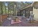Back deck with fire pit and seating area, wooded view at 365 Pendleton Trl, Tyrone, GA 30290