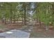 Long driveway leading to a home nestled amongst trees at 365 Pendleton Trl, Tyrone, GA 30290