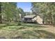Back of house showing deck and tree-filled backyard at 365 Pendleton Trl, Tyrone, GA 30290