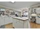 Bright eat-in kitchen with island, white cabinets, and hardwood floors at 365 Pendleton Trl, Tyrone, GA 30290