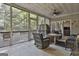 Spacious screened porch with wicker furniture and view of backyard at 365 Pendleton Trl, Tyrone, GA 30290