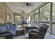 Relaxing screened porch with wicker furniture and fire pit at 365 Pendleton Trl, Tyrone, GA 30290