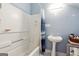 Small bathroom with pedestal sink and shower/tub combo at 12030 Turner Rd, Hampton, GA 30228