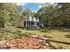 Exterior of a house nestled in a wooded area with a large yard at 12030 Turner Rd, Hampton, GA 30228