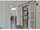 Large walk-in closet with barn doors and ample hanging space at 100 Roxbrough Ln, Fayetteville, GA 30215