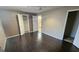 Bedroom with dark laminate wood flooring and an attached bathroom at 6140 Amado Ct, Rex, GA 30273