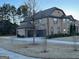 Brick home with a three-car garage and a large driveway at 2801 Karras Cv, Hampton, GA 30228