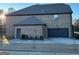 Brick home with a three-car garage and a large backyard at 2801 Karras Cv, Hampton, GA 30228