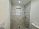 Modern bathroom with a walk-in shower and marble tile at 2803 Norgate Ln, Decatur, GA 30034