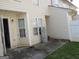 Small back patio with access door and exterior wall at 2055 Grove Way, Hampton, GA 30228