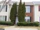 Brick front exterior of townhome with landscaping and two-story design at 2055 Grove Way, Hampton, GA 30228