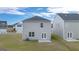 Rear view of two-story house with patio at 11996 Conrad Cir # 128, Hampton, GA 30228