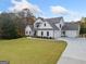 White two-story house with three-car garage at 119 Griffin Way, Canton, GA 30115