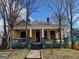 Yellow house with a wrap around porch, and mature trees at 1786 Lakewood Se Ave, Atlanta, GA 30315