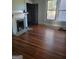 Spacious living room with hardwood floors and a fireplace at 1786 Lakewood Se Ave, Atlanta, GA 30315