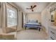 Bedroom with queen bed, ceiling fan, and large windows at 480 Mitchell Rd, Covington, GA 30014