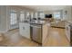 Open concept kitchen with island, stainless steel appliances, and access to deck at 480 Mitchell Rd, Covington, GA 30014