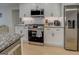 Modern kitchen boasts stainless steel appliances and white shaker cabinets at 480 Mitchell Rd, Covington, GA 30014