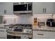 Stainless steel appliances and granite countertops in this modern kitchen at 480 Mitchell Rd, Covington, GA 30014