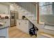 Kitchen features white cabinets, granite counters and staircase access at 480 Mitchell Rd, Covington, GA 30014