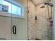 Modern shower with marble tile and glass door at 480 Mitchell Rd, Covington, GA 30014