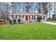 Ranch style home with gray exterior, red door, and green lawn at 2252 Brannen Se Rd, Atlanta, GA 30316