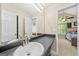 Bathroom with gray vanity, white sink, and a view of a bedroom at 4197 Arnolds Mill Opas, Douglasville, GA 30135