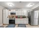Kitchen with white cabinets, stainless steel appliances, and wood floors at 4197 Arnolds Mill Opas, Douglasville, GA 30135