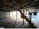 Unfinished basement with a garage door and stairs leading to the main level at 2816 Cloverhurst Dr, East Point, GA 30344