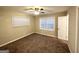 Well-lit bedroom featuring neutral carpeting and a ceiling fan at 3029 Mckenzie Rd, East Point, GA 30344