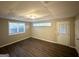 Bright bedroom with wood-look floors, large window, and exterior access at 3029 Mckenzie Rd, East Point, GA 30344