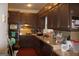 Kitchen featuring dark brown cabinets, granite countertops, and appliances at 732 Country Lake Drive Dr, Hampton, GA 30228