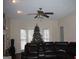 Living room featuring a sectional sofa, Christmas tree, and ceiling fan at 732 Country Lake Drive Dr, Hampton, GA 30228
