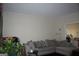 Living room with gray sectional sofa and large window at 732 Country Lake Drive Dr, Hampton, GA 30228